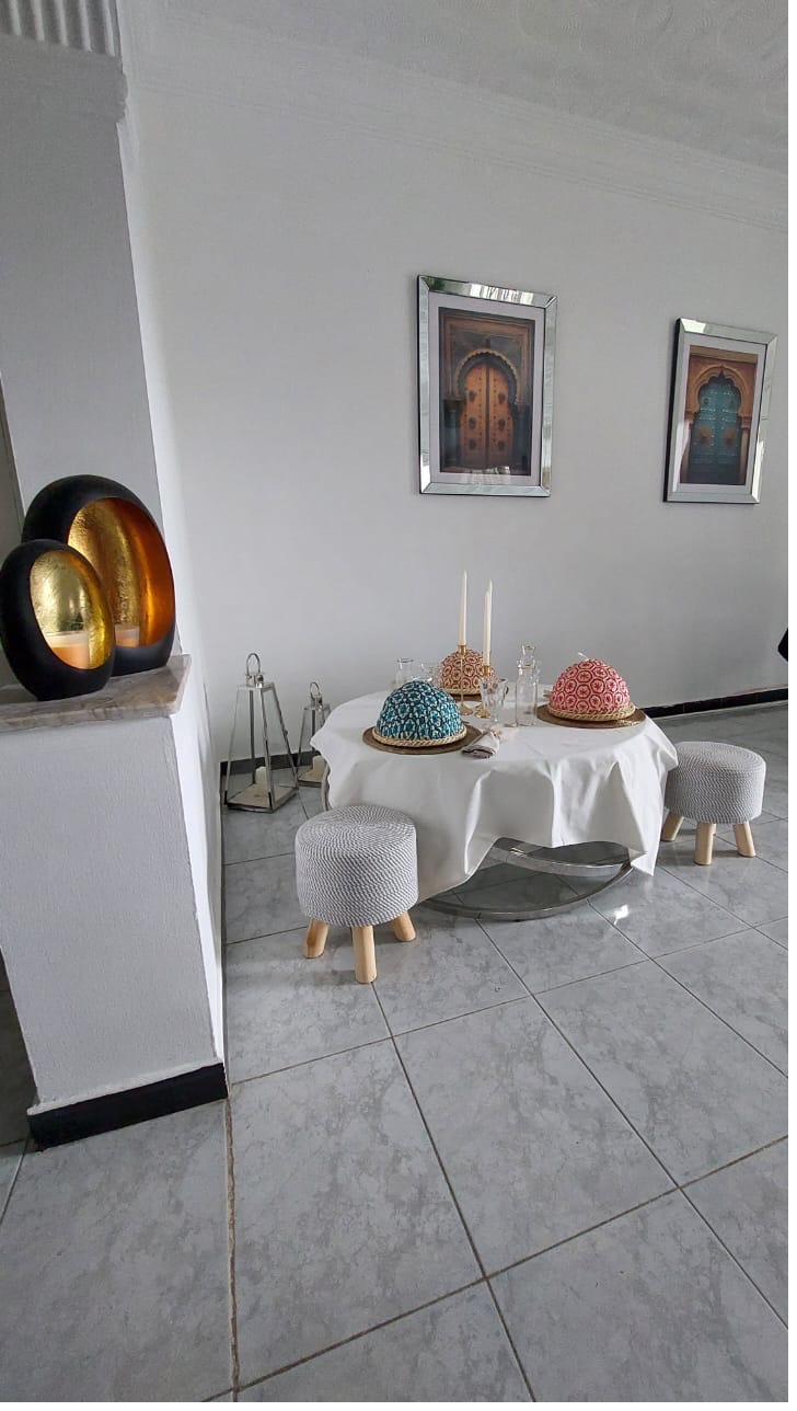 Détail décoration salle à manger : portes marocaines encadrées, sphères dorées, candélabres